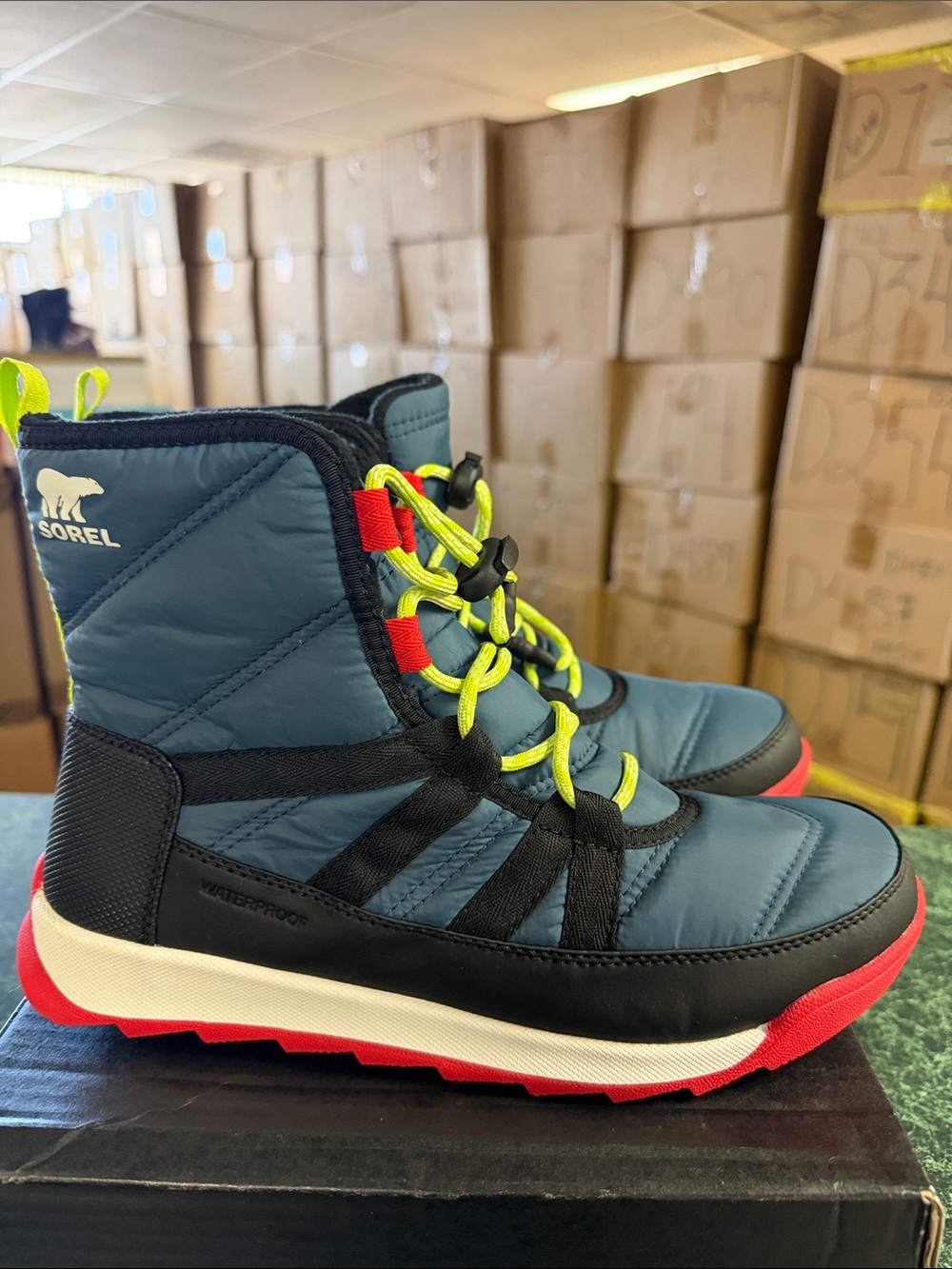 Sorel Blue Quilted Winter Boots with Neon Yellow Laces and Red Soles